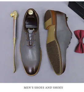 Detailed top view of grey leather oxford shoes with calligraphy embossing and shoehorn