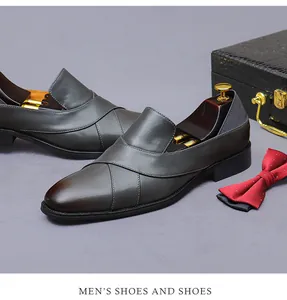 Detail of dark gray leather loafers with gradient toe and business accessories set