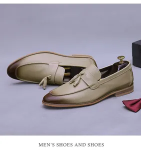 Detail of men's leather loafers with tassel fringe and brown gradient toe effect