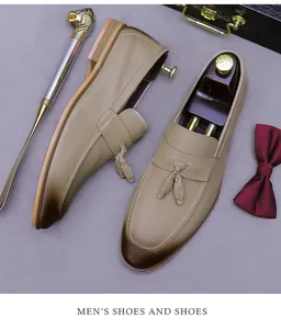 Detail of tan leather men's tassel loafers with gradient toe and luxury accessories
