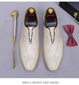 Detail of cream leather oxford shoes with elegant script print and purple laces