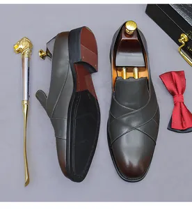 Close-up of premium gradient leather loafers with lion head shoehorn and bow tie set