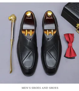 Flat lay of black leather dress shoes with cedar shoe trees and gentlemen accessories