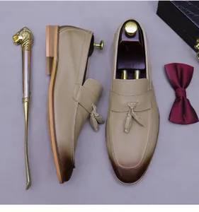 Detail of men's tassel loafers in genuine leather with gradient toe and luxury accessories