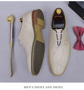 Detail view of leather oxford shoe with script print, shoe horn, and formal bowtie