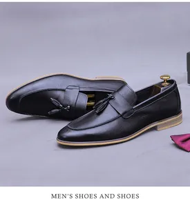 Close-up of black tassel loafers with lychee grain leather and layered wooden sole