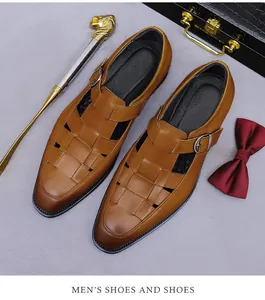 Close-up of brown leather woven monk strap sandals with metal buckles and business accessories
