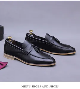 Detailed close-up of men's black leather tassel loafers with classic wood grain heel detail