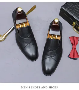 Top view of black leather loafers with cross-over design and elegant gentleman accessories