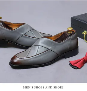 Detailed close-up of grey leather dress shoes with gradient brown toe and fine stitching