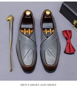 Close-up of gray-brown leather loafers with crossover design, shoe tree, and bowtie set