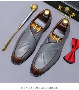 Detail of grey men's leather loafers with retro burnished brown toe and dandy accessories