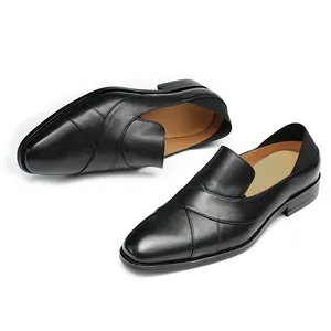 Classic black leather loafers for men with a unique overlapping strap design on a white background