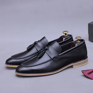 Classic black leather loafers for men featuring elegant tassels and textured grain finish
