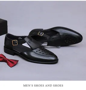 Detail of black leather men's sandals with hollow patterns and buckle on a gift box background