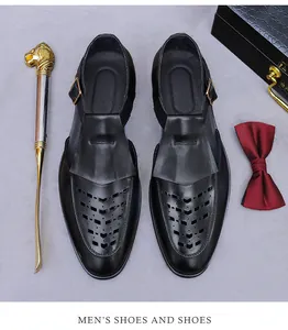 Macro detail of men's hollow-out leather sandal with gold buckle and lion shoehorn