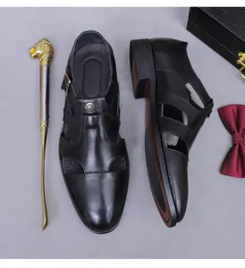 Close-up of black leather monk strap sandals with cutout details for business attire