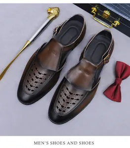 Close-up of brown leather hollow-out sandals with buckle strap and laser-cut patterns