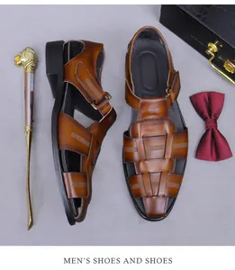 Flachbild von braunen geflochtenen Ledersandalen für Herren mit Schuhanzieher und Fliege