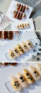 Detail of retro floral press-on nails with amber tones and elegant rose patterns