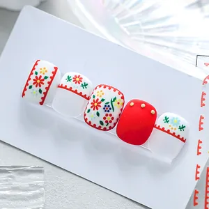 Matte floral nail art stickers in red and white with small 3D golden ornaments