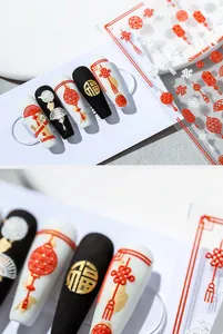 Macro shot of 5D embossed nail stickers featuring red lanterns and Chinese knots