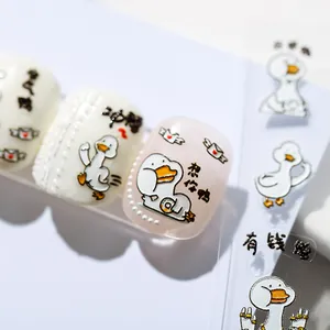 5D cartoon duck nail stickers with cute patterns applied on glossy pink and white nails