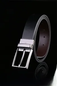 Detail of classic black leather belt showing silver metal pin buckle and textured strap
