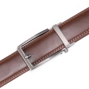 Macro shot of brown leather belt showing fine texture, double stitching, and brushed metal buckle