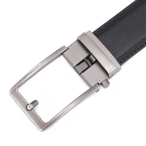 Detail of gunmetal buckle with brushed texture on black litchi grain leather belt