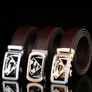 Detail view of premium leather belts featuring polished alloy Superman logo buckles