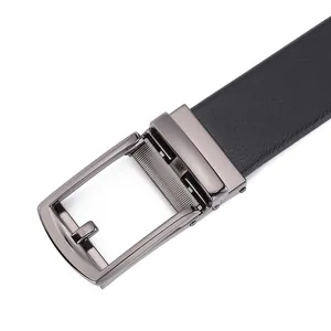 Detailed macro of black lychee grain leather belt with gunmetal ratchet buckle finish