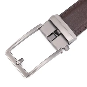 Close-up of men's genuine leather belt with brushed metal buckle and brown stitching