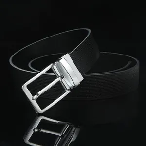 Close-up of men's black leather belt with woven texture and silver polished buckle