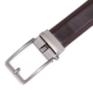 Detail of dark brown leather belt featuring double stitching and brushed metal pin buckle