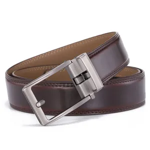 Detail of dark brown leather belt featuring brushed metal buckle and fine edge stitching