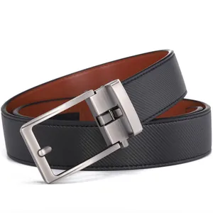Detail view of reversible men's leather belt with silver brushed rotatable buckle