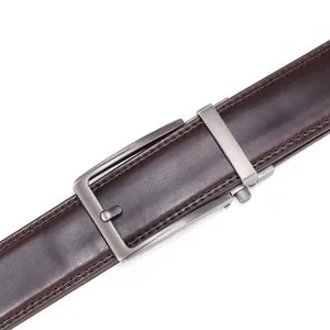 Close-up of brown leather belt with double stitching and gunmetal alloy buckle