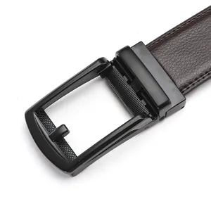 Close-up of matte black automatic belt buckle with textured brown leather strap details