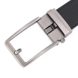 Detail of men leather belt showing gunmetal brushed alloy buckle and black carbon fiber texture