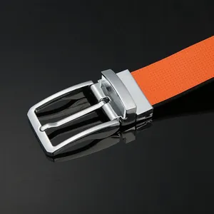 Detail of orange leather belt with silver needle buckle and micro-pore texture design