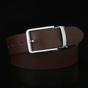 Detail of dark brown leather belt with fine perforated texture and silver metal buckle