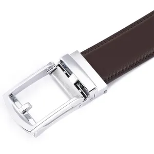 Detail of men's brown lychee leather belt with a polished silver automatic buckle