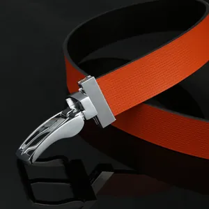 Men's orange leather belt with perforated texture and silver automatic buckle on black surface