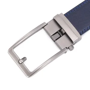 Macro detail of men's leather belt featuring brushed dark grey metal buckle and blue textured strap