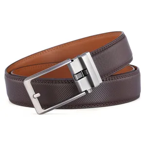 Detail of reversible brown leather belt with diamond texture and rotating silver buckle