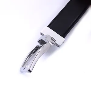 Detail of silver metal buckle and premium black leather texture on men's formal belt