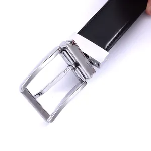 Close-up of men's leather belt with polished silver pin buckle and stitching details
