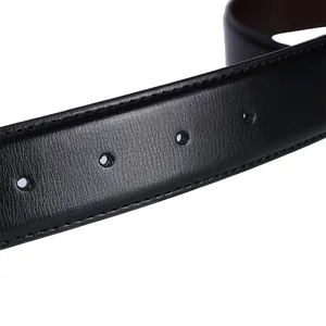 Close-up of black and brown reversible leather belt with lychee texture and fine stitching