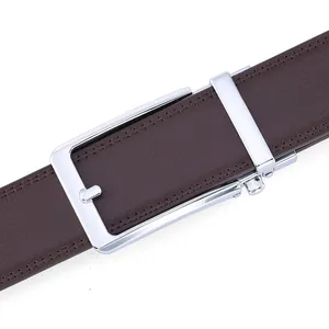 Detail of silver automatic buckle and dark brown lychee leather texture on men's belt